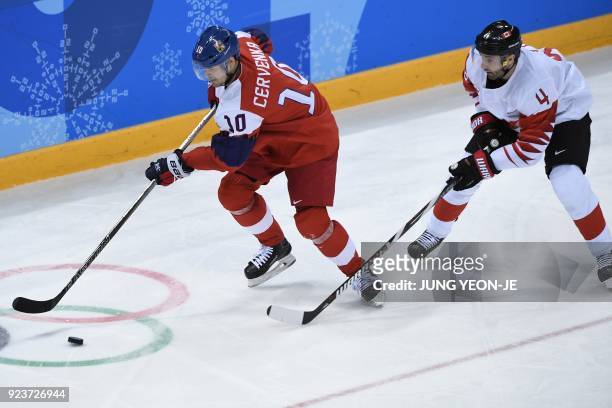 Czech Republic's Roman Cervenka and Canada's Chris Lee fight for the puck in the men's bronze medal ice hockey match between the Czech Republic and...