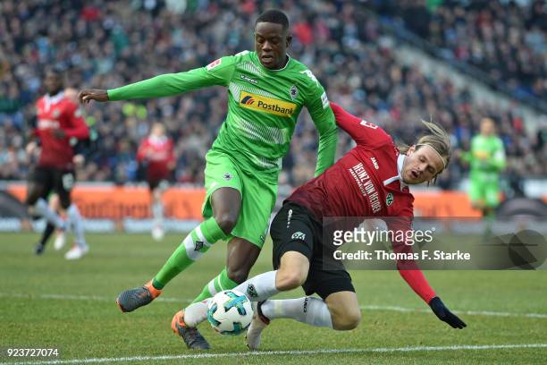Iver Fossum of Hannover tackles Denis Zakaria of Moenchengladbach during the Bundesliga match between Hannover 96 and Borussia Moenchengladbach at...