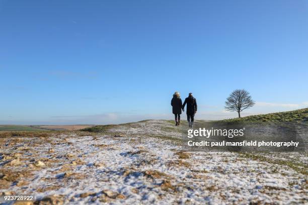 couple walking - mature woman winter stock-fotos und bilder