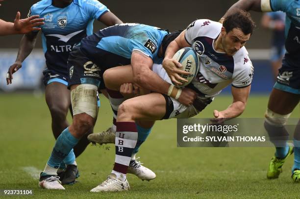 Bordeaux-Begles' French fullback Nans Ducuing is tackled by Montpellier's French number eight Alexandre Dumoulin during the French Top 14 rugby union...