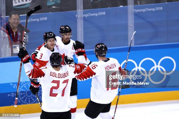 Chris Kelly of Canada celebrates with teammates after scoring in the third period against Czech Republic during the Men's Bronze Medal Game on day...