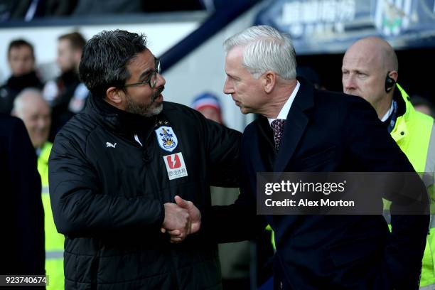 David Wagner, Manager of Huddersfield Town and Alan Pardew, Manager of West Bromwich Albion shake hands ahead of the Premier League match between...