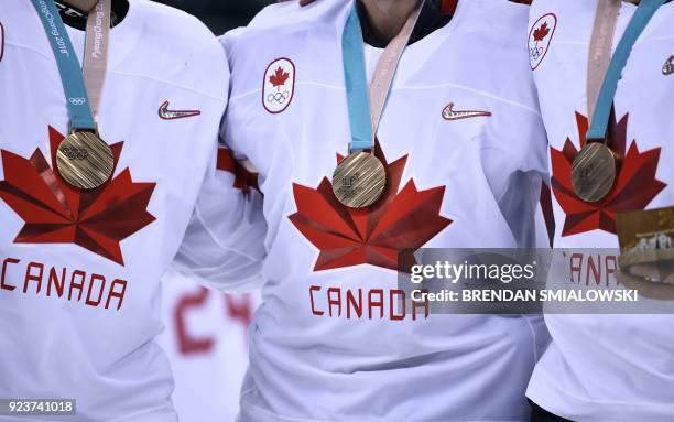 Canada's Justin Peters , Kevin Poulin and Ben Scrivens pose with their bronze medals after the medal ceremony after winning the men's bronze medal...