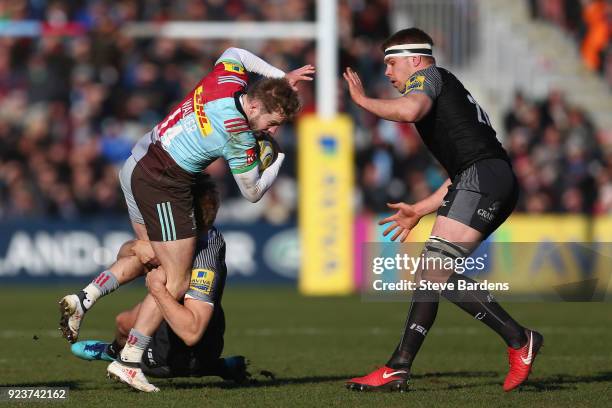 Charlie Walker of Harlequins is tackled by Chris Harris of Newcastle Falcons during the Aviva Premiership match between Harlequins and Newcastle...