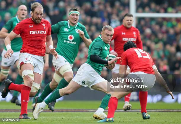 Ireland's wing Keith Earls is tackled by Wales' full-back Leigh Halfpenny during the Six Nations international rugby union match between Ireland and...