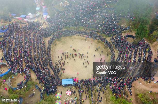 Villagers watch bulls fight against each other during a competition at Congjiang County on February 24, 2018 in Qiandongnan Miao and Dong Autonomous...