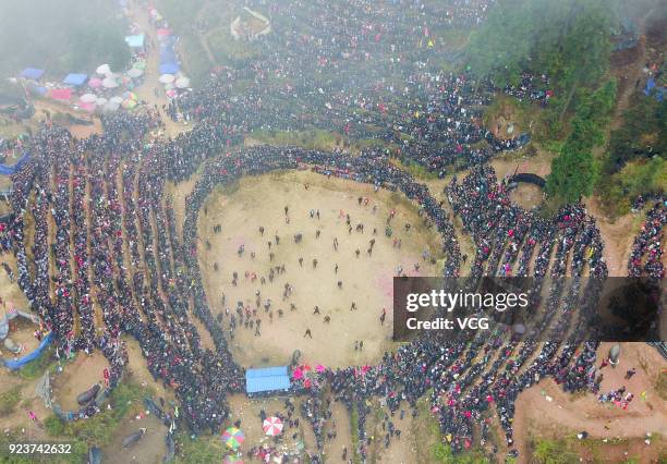 Villagers watch bulls fight against each other during a competition at Congjiang County on February 24, 2018 in Qiandongnan Miao and Dong Autonomous...