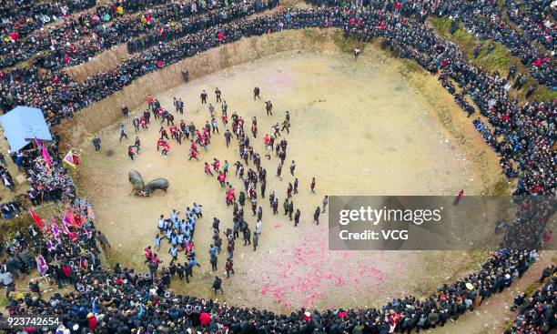 Villagers watch bulls fight against each other during a competition at Congjiang County on February 24, 2018 in Qiandongnan Miao and Dong Autonomous...