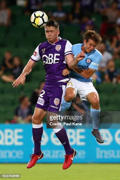 Alex Grant of the Glory is challenged by Nick Fitzgerald of Melbourne during the round 21 A-League match between the Perth Glory and Melbourne City...