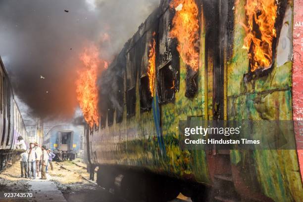 Fire broke out in an empty coach of Pune-New Delhi Duronto Express parked at the yard near Sangam Park, on February 23, 2018 in Pune, India. Fire...