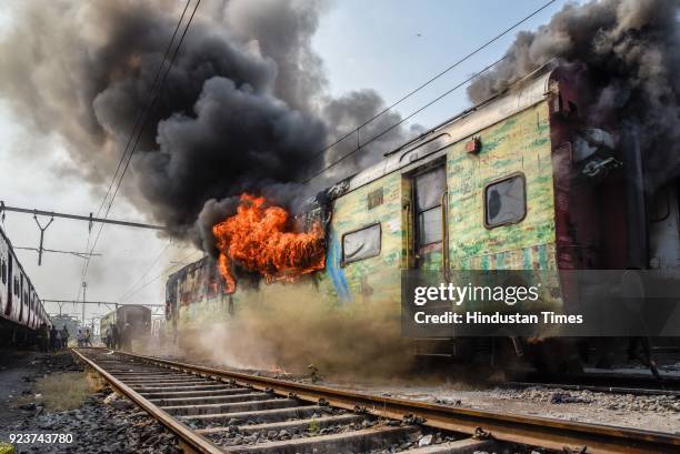 Fire broke out in an empty coach of Pune-New Delhi Duronto Express parked at the yard near Sangam Park, on February 23, 2018 in Pune, India. Fire...