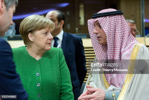 German Chancellor Angela Merkel is talking with the Saudi Minister of Foreign Affairs Adel bin Ahmed Al-Jubeir during a round table meeting of the...