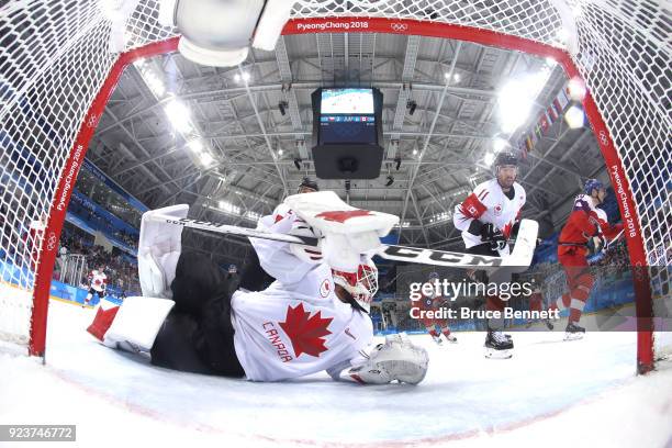 Kevin Poulin of Canada allows a goal in the third period against Roman Cervenka of the Czech Republic during the Men's Bronze Medal Game on day...