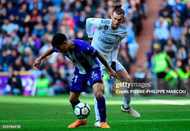 Alaves' Paraguayan forward Hernan Perez vies with Real Madrid's Welsh forward Gareth Bale during the Spanish league football match between Real...