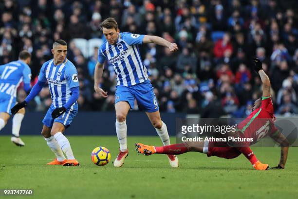 Dale Stephens of Brighton tackled by Jordan Ayew of Swansea City during the Premier League match between Brighton and Hove Albion and Swansea City...