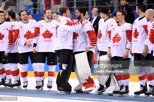 Bronze medal winners Ben Scrivens and Kevin Poulin of Canada celebrate with teammates after defeating Czech Republic 6-4 during the Men's Bronze...