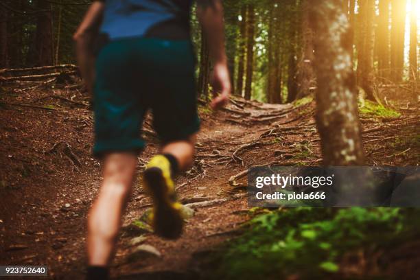 man trail running in the forest - running spikes stock pictures, royalty-free photos & images