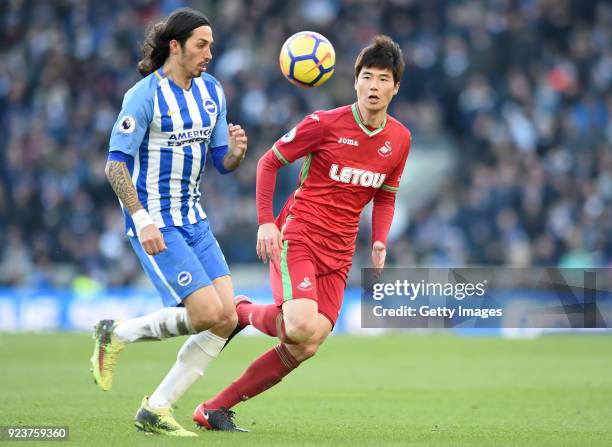 Ki Sung-Yueng of Swansea City challenges Matias Ezequiel Schelotto of Brighton and Hove Albion during the Premier League match between Brighton and...