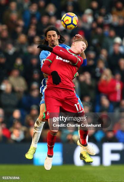 Samuel Clucas of Swansea City and Matias Ezequiel Schelotto of Brighton and Hove Albion battle for the header during the Premier League match between...