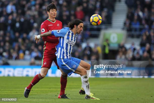Ki Sung-Yueng of Swansea City challenges Ezequiel Schelotto of Brighton during the Premier League match between Brighton and Hove Albion and Swansea...