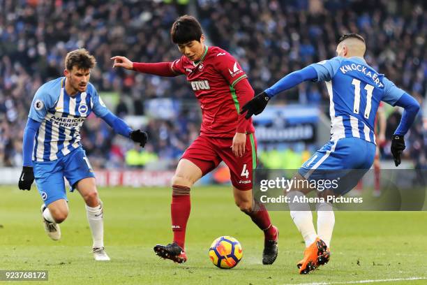 Ki Sung-Yueng of Swansea City gets past Pascal Gross and Anthony Knockaert of Brighton during the Premier League match between Brighton and Hove...