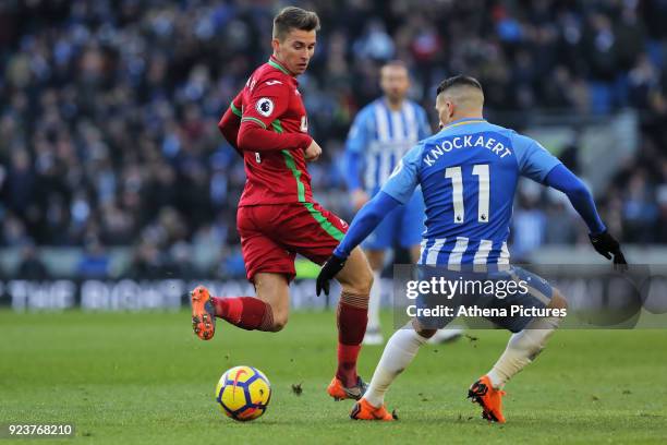 Tom Carroll of Swansea City kicks the ball back past Anthony Knockaert of Brighton during the Premier League match between Brighton and Hove Albion...