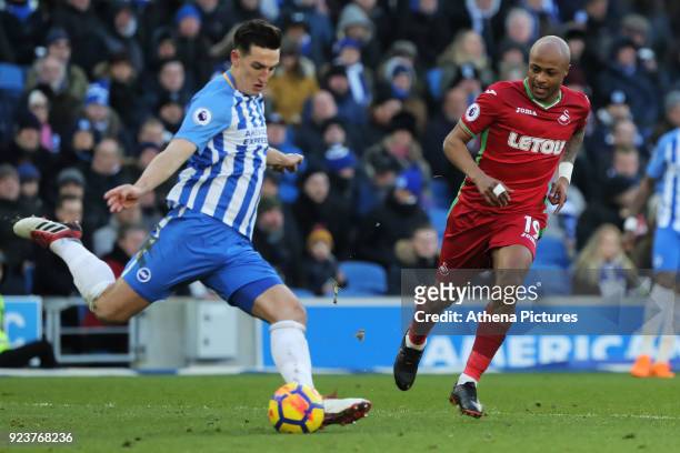Lewis Dunk of Brighton kicks the ball away from Andre Ayew of Swansea City during the Premier League match between Brighton and Hove Albion and...