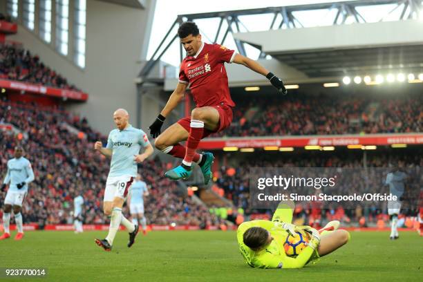 Dominic Solanke of Liverpool jumps over the advancing West Ham goalkeeper Adrian during the Premier League match between Liverpool and West Ham...