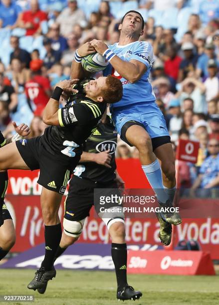 Bulls' Warrick Gelant and Hurricanes' Ihaia West jump for the ball during the SUPER XV Rugby match between Bulls and Hurricanes at Loftus Rugby...