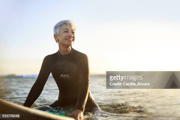 surf the horizon - active seniors surfing stock pictures, royalty-free photos & images