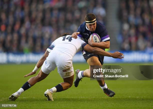 Stuart McInally of Scotland is tackled by Anthony Watson of England during the NatWest Six Nations match between Scotland and England at Murrayfield...