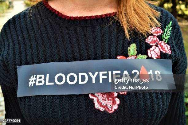 Photo taken in Ankara, Turkey on February 24, 2018 shows a woman wearing a sticker that reads the hashtag of 'Bloody FIFA 2018' as Russian female...