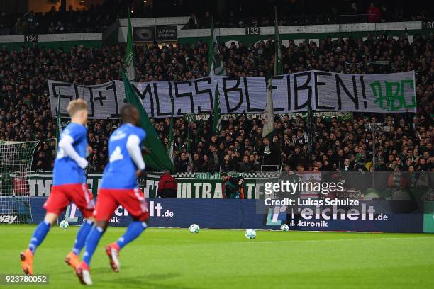 Players of Hamburg warm up as supporters of Bremen display a banner in support of the 50+1 rule, before the Bundesliga match between SV Werder Bremen...