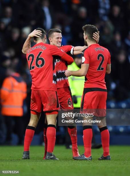 Jonathan Hogg of Huddersfield Town celebrates his side's win with Christopher Schindler and Tommy Smith following the Premier League match between...