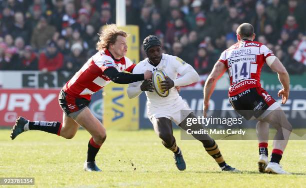 Christian Wade of Wasps is tackled by Billy Twelvetree and Charlie Sharples of Gloucester during the Aviva Premiership match between Gloucester Rugby...