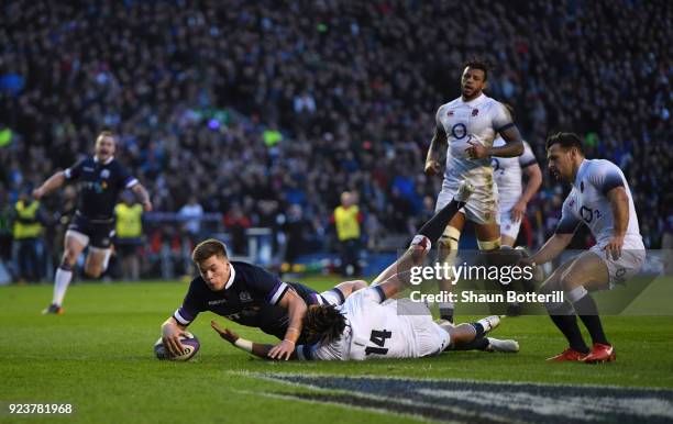 Huw Jones of Scotland scores the third try under pressure from Anthony Watson of England during the NatWest Six Nations match between Scotland and...