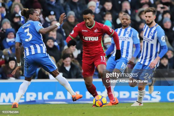 Luciano Narsingh of Swansea City gets past Gaetan Bong and another two Broghton players during the Premier League match between Brighton and Hove...