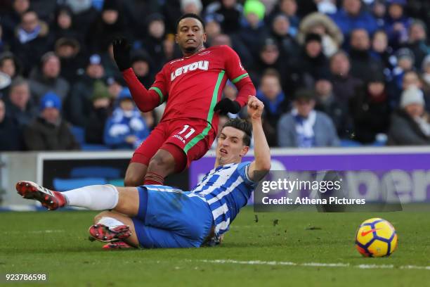 Lewis Dunk of Brighton lunges towards Luciano Narsingh of Swansea City during the Premier League match between Brighton and Hove Albion and Swansea...