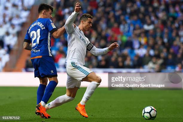 Cristiano Ronaldo of Real Madrid competes for the ball with Hernan Perez of Deportivo Alaves during the La Liga match between Real Madrid and...