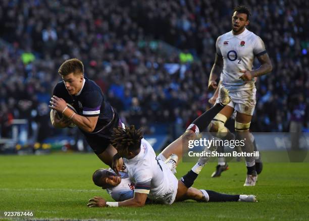 Huw Jones of Scotland scores the third try under pressure from Anthony Watson of England during the NatWest Six Nations match between Scotland and...