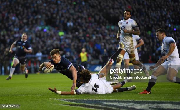 Huw Jones of Scotland scores the third try under pressure from Anthony Watson of England during the NatWest Six Nations match between Scotland and...