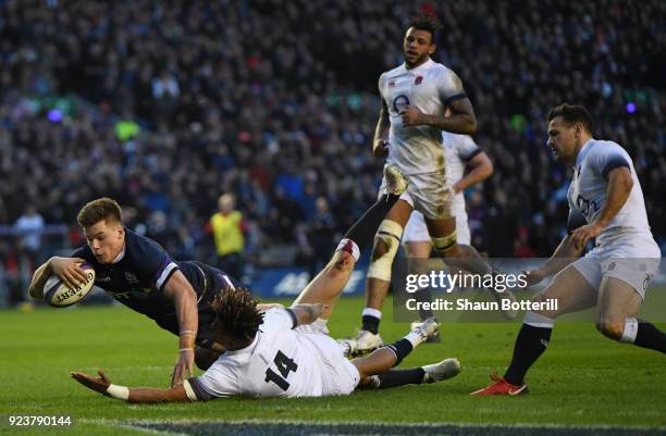 Huw Jones of Scotland scores the third try under pressure from Anthony Watson of England during the NatWest Six Nations match between Scotland and...