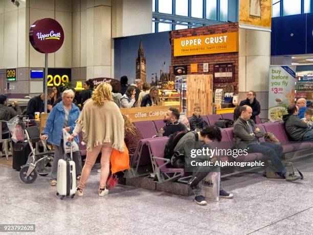 manchester airport shops with passengers - manchester airport stock pictures, royalty-free photos & images