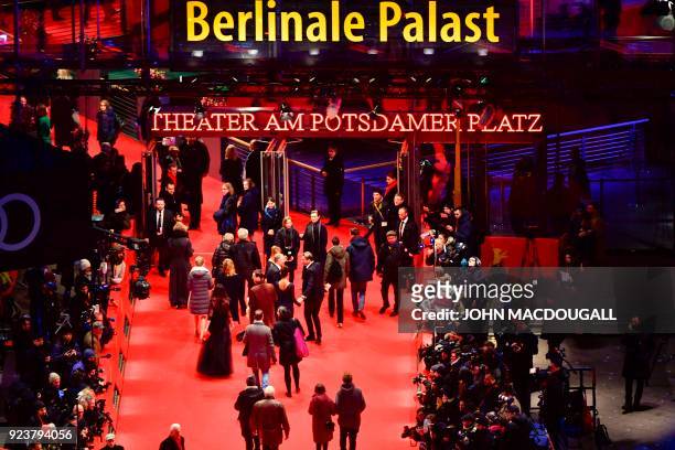 Overall view shows guests and stars arriving on the red carpet before the awards ceremony of the 68th edition of the Berlinale film festival on...