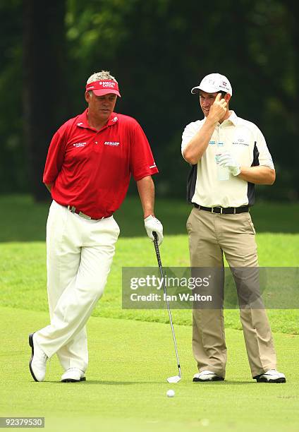 Darren Clark of Northern Ireland and Padraig Harrington of Ireland during the practice round of the Barclays Singapore Open at Sentosa Golf Club on...