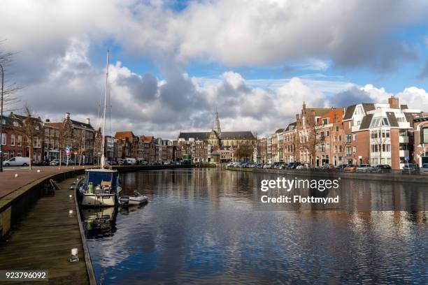 view from the river spaarne towards the historical city center of haarlem - haarlem netherlands stock pictures, royalty-free photos & images