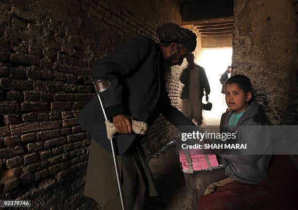 An Afghan man buys toilet paper from ten year old street vendor Aziza Hamad in Kabul on October 27, 2009. Afghanistan's presidential rivals are...