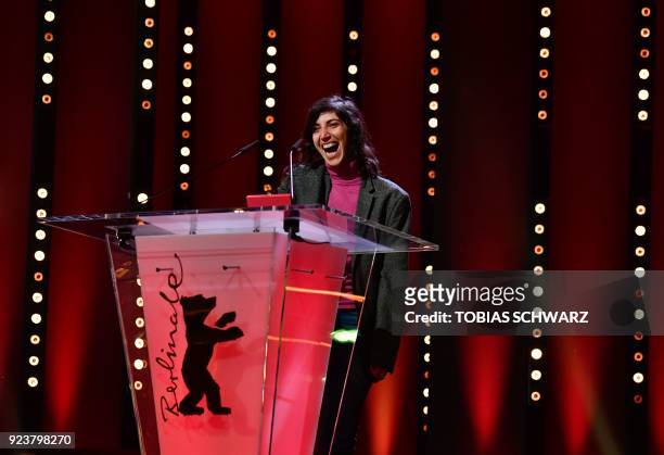 Ines Moldavsky speaks to the audience after being awarded the Golden Bear for the Best Short Film for "The Men Behind the Wall" during the awards...