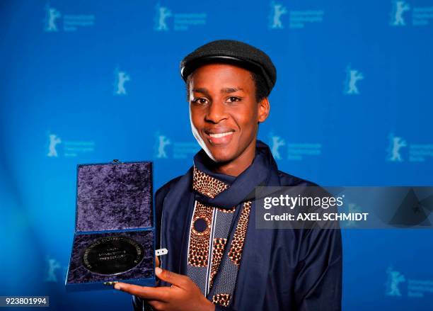 Samuel Ishimwe poses with his Silver Bear short film award for the movie "Imfura" during the awards ceremony of the 68th edition of the Berlinale...