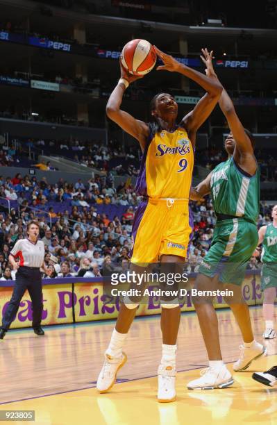 Lisa Leslie of the Los Angeles Sparks puts up a shot over Janell Burse of the Minnesota Lynx in the game on June 21, 2002 at Staples Center in Los...